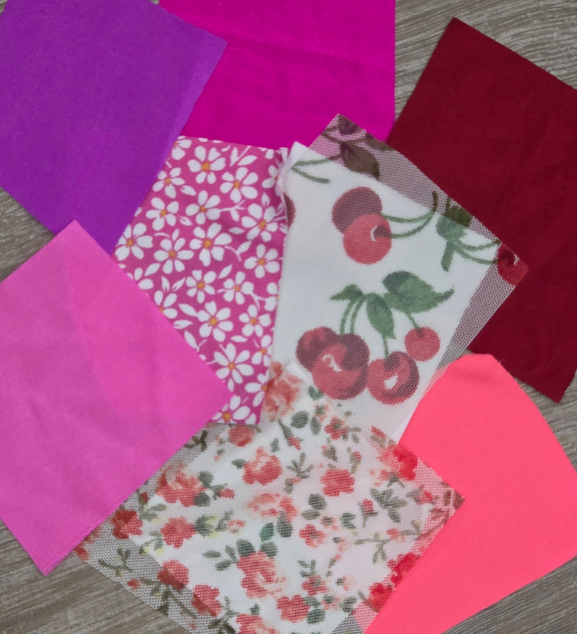 Bright Pop Collection featuring vibrant pink, purple, red, cherry print, and daisy print dancewear fabrics arranged in a bold color flat lay.