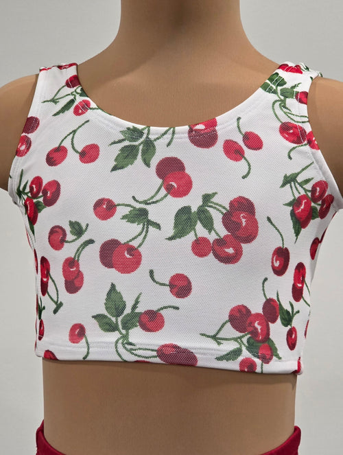 White crop top with red cherry pattern on a plain background